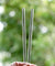 holding 2 bendy glass straws during the day outdoors 8mm wide