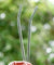 hands holding 2 straight glass straws during the day outdoors 8mm wide